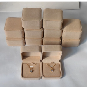 Detail view of beige velvet jewelry boxes with soft lining for necklaces and rings