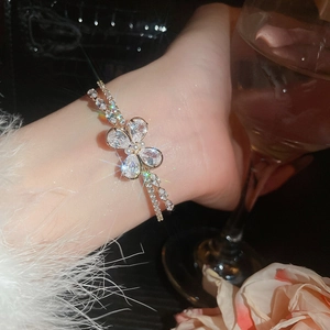 Close-up of sparkling zircon butterfly bracelet with double layer chain on woman wrist
