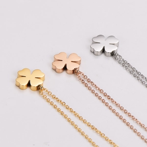 Three minimalist stainless steel four-leaf clover necklaces in gold, rose gold and silver