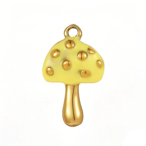 Detailed macro view of yellow enamel mushroom pendant with golden spots and metal accents