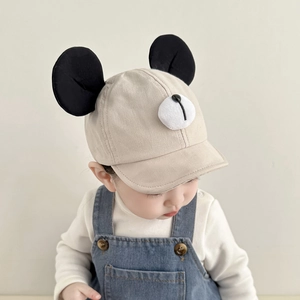 Cute beige baby baseball cap with black round ears and plush ball bear nose detail