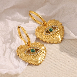 Close-up of gold heart earrings with malachite eye and surrounding white zircons
