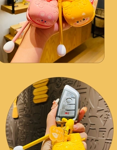 Close-up of cute cartoon keychains for car keys with salary plus one flower tag detail