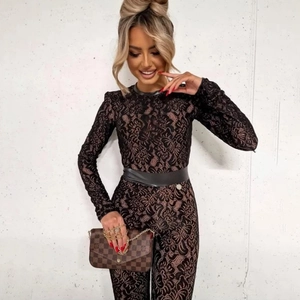 Detail view of fashion black lace bodysuit with long sleeves and leather waist belt accent