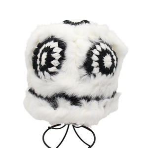 Plush white faux fur bucket hat with black and white crochet floral pattern for winter