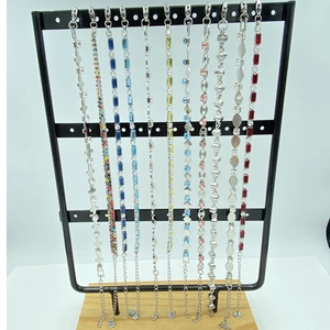 Titanium steel bracelets set with colorful cubic zirconia displayed on vertical racks