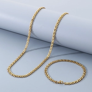 Detail of gold geometric link necklace and bracelet set with rectangle hollow design
