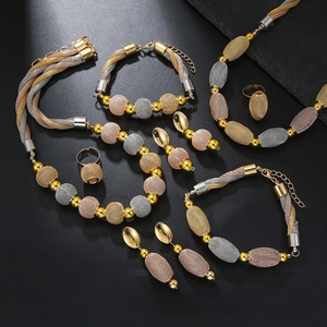 Detailed view of tricolor woven mesh ball jewelry set featuring gold silver and rose gold tones