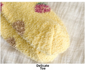 Detail shot of the reinforced toe on thick yellow coral fleece socks with strawberry patterns