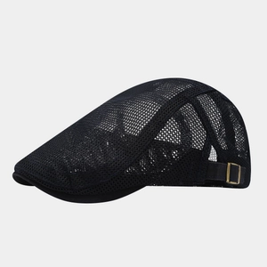 Detail of navy mesh flat cap showing breathable fabric and brass side adjustment buckle