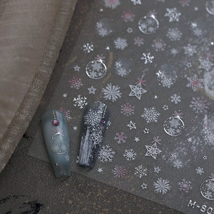 Winter snowflake embossed nail stickers with metallic silver and white star patterns