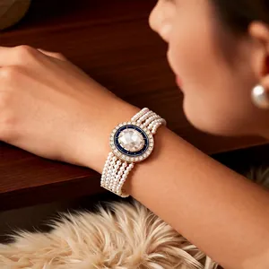 Luxurious four-layer pearl bracelet with blue enamel oval stone and golden metal finish