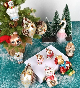 Close-up of painted glass Christmas animal ornaments on a decorated festive tree