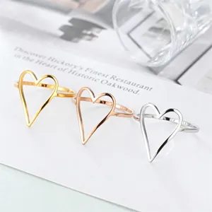 Minimalist stainless steel hollow heart rings in gold, silver, and rose gold finishes