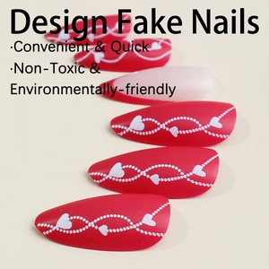 Red almond press-on nails with white heart line patterns and matte finish