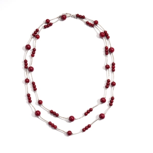 Double-layer necklace with deep red beads and silver twisted chains on white backdrop