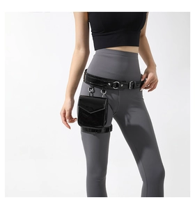 Close-up of black glossy PU leather leg bag with adjustable straps and metal buckles