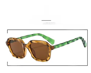 Detail close-up of wavy texture frames and amber green color on these stylish sunglasses