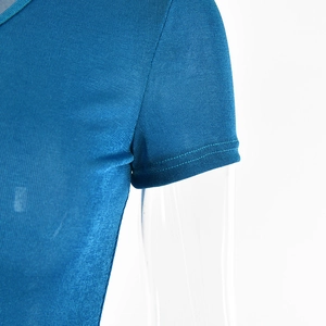 Detailed close-up of blue short sleeve dress showing silky knit fabric and stitching
