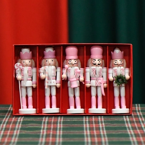 Five pink and white 13cm wooden nutcracker soldier dolls in a festive red holiday gift box
