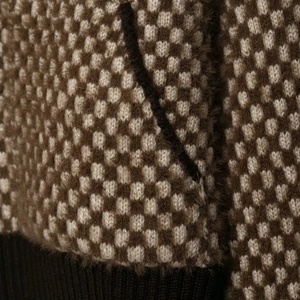 Mixed color checkerboard knit sweater with fuzzy mohair texture and ribbed hem detail