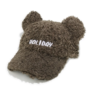Detail of dark brown teddy fleece baseball cap with cute bear ears and HOLIDAY embroidery