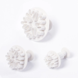 Set of three white plastic snowflake plunger cutters for cookie and fondant decorating