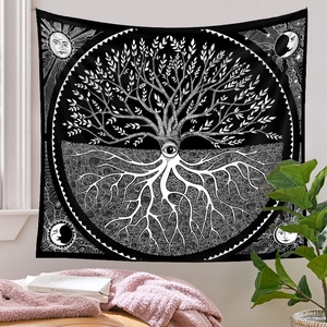 Detail of bohemian black and white tapestry featuring tree of life with sun and moon