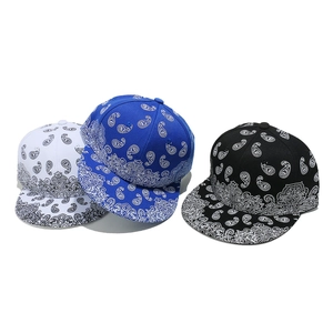 Three paisley print snapback baseball hats in white, blue and black street style