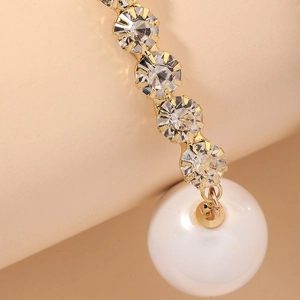 Elegant gold drop earrings with five aligned crystals and a large round pearl drop