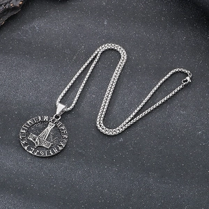 Detailed view of silver Viking Mjolnir pendant with runic circle on a steel box chain