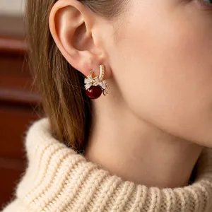 18k gold plated hoop earrings featuring sparkling rhinestones and a red round bead pendant