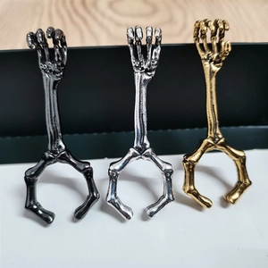 Skeleton hand cigarette holder rings in black, gold, and silver finishes for smoking