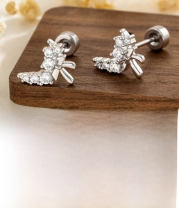 Detailed view of silver bow cartilage stud with micro-paved zircons and screw back