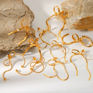 18k gold plated stainless steel bow earrings with fluid metal ribbon design on stones