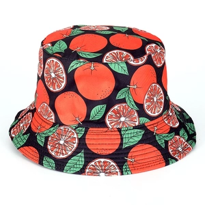 Detail of black cotton bucket hat featuring bright orange and grapefruit fruit print