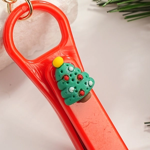 Cartoon Christmas tree nail clipper keychain with red base and festive holiday decor