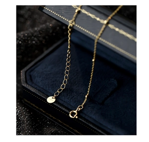 Detailed macro view of S925 sterling silver gold-plated lobster clasp and extension chain