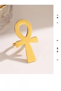 Detailed close-up of polished golden Ankh cross ring with a smooth mirror finish
