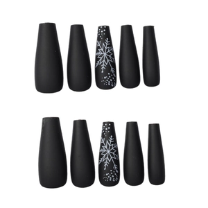 Matte black long press-on nails with white snowflake patterns for Christmas season