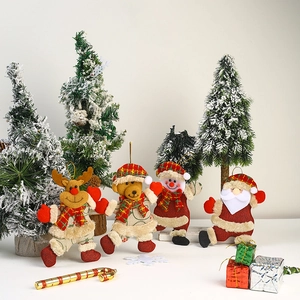 Detail of plush Christmas tree ornaments featuring Santa, snowman, elk, and bear doll sets