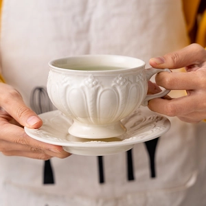 British vintage white ceramic coffee cup and saucer with elegant embossed floral patterns