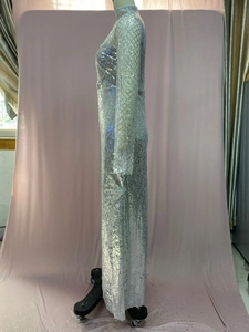 Detail of silver sequin evening gown showing shimmering round paillettes and slim fit design