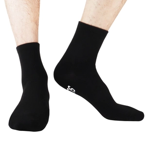 Close-up of black cotton mid-calf socks for men featuring anti-slip bottom lettering