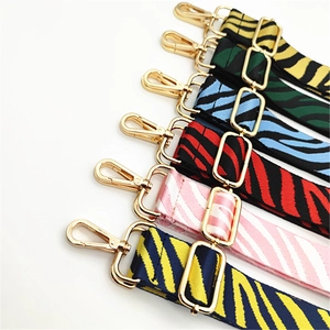 Adjustable zebra print woven shoulder straps with gold hardware in vibrant color options
