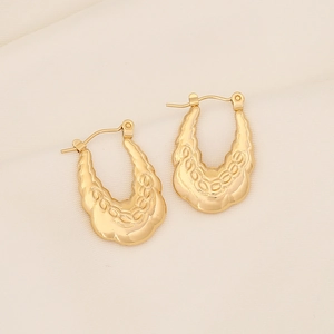 U-shaped gold stainless steel earrings with embossed chain texture on silk backdrop