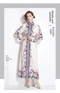 Detail of floral printed maxi dress with mandarin collar and black lace trim on the hem