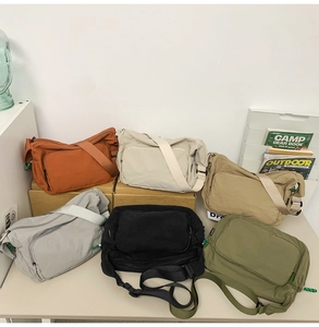 Multiple colors of water-resistant nylon messenger bags with adjustable straps