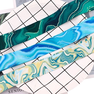 Detailed view of marble patterned lanyards with golden textures in green, blue and yellow colors