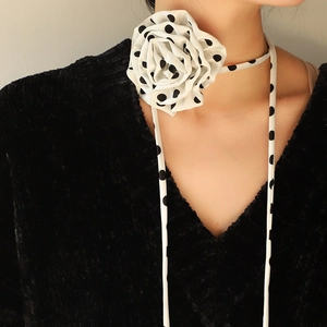 Chiffon polka dot rose flower choker with long ribbons worn by a fashion model